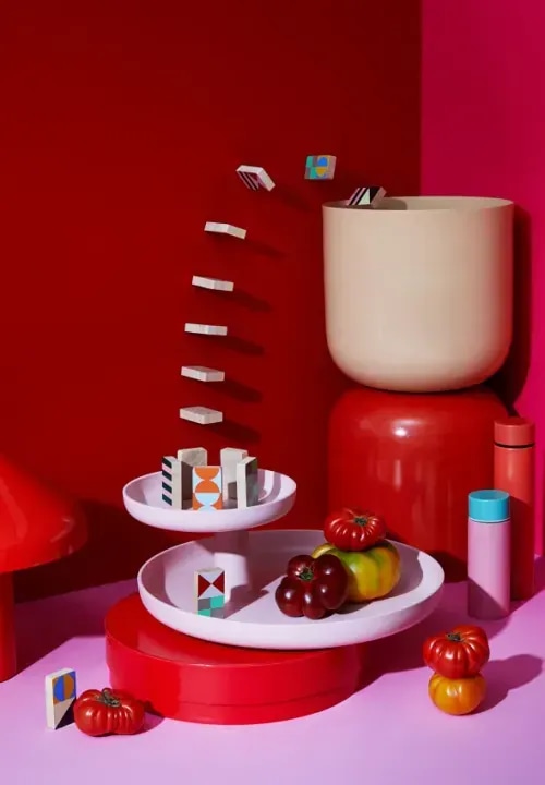 An array of vintage home items on a bright, red background.