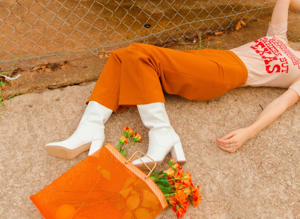 Woman in orange pants lying on the ground